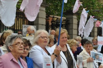 symphysiotomy protest, women holding a clothesline of baby's clothes.