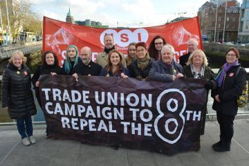 Members of the trade union campaign to repeal the 8th amendment stand with their banner